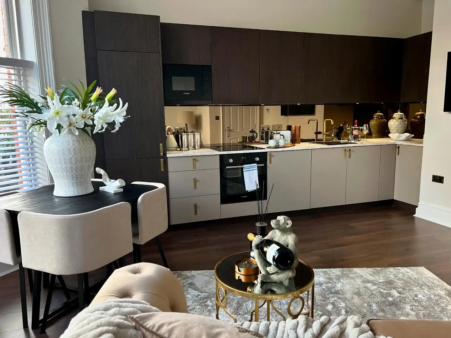 Open kitchen and dining area with white lilies