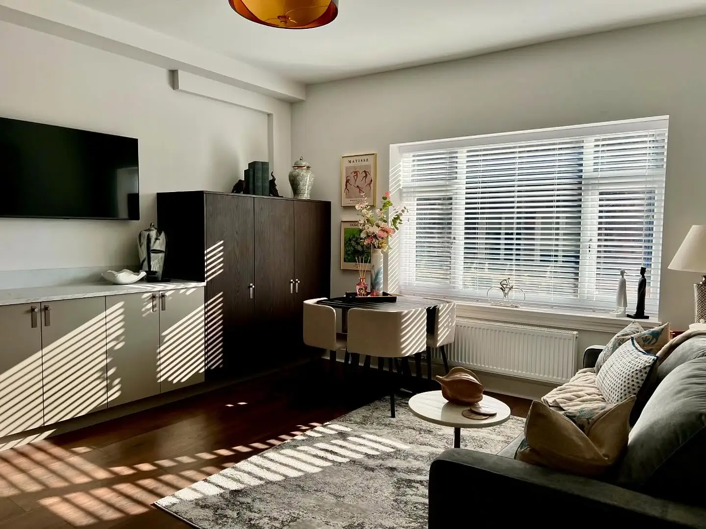 Lounge and kitchen in low sun through the blinds