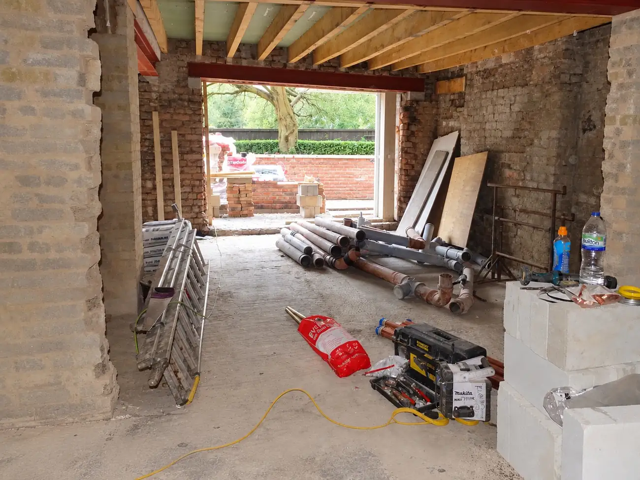 Before: the same space as a building site with bare block walls, open to the garden