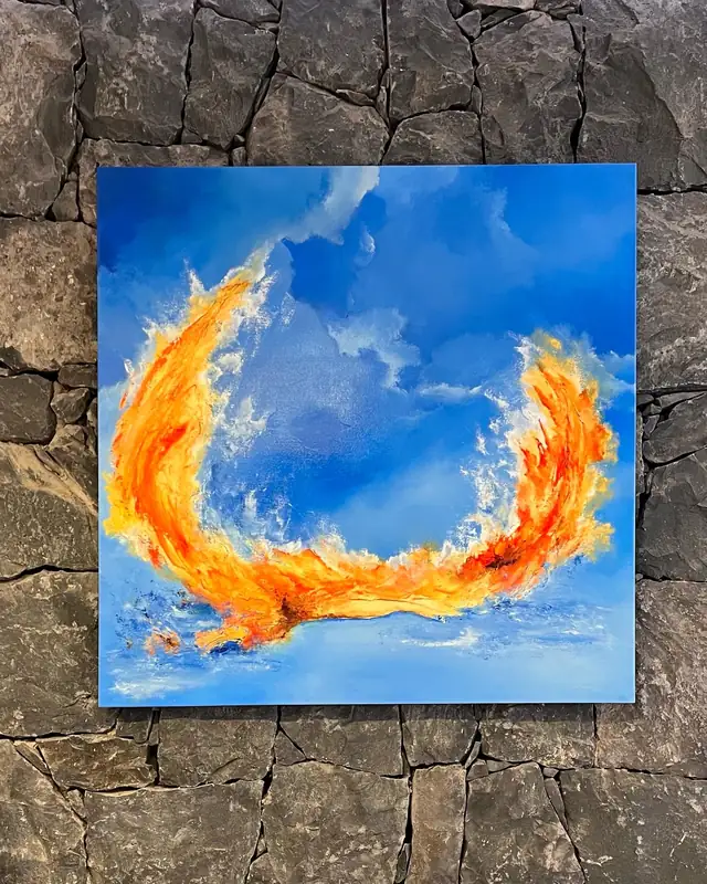 Phoenix Blue, a 100 by 100 centimetre painting, hung on a lava stone wall at Baobab Suites